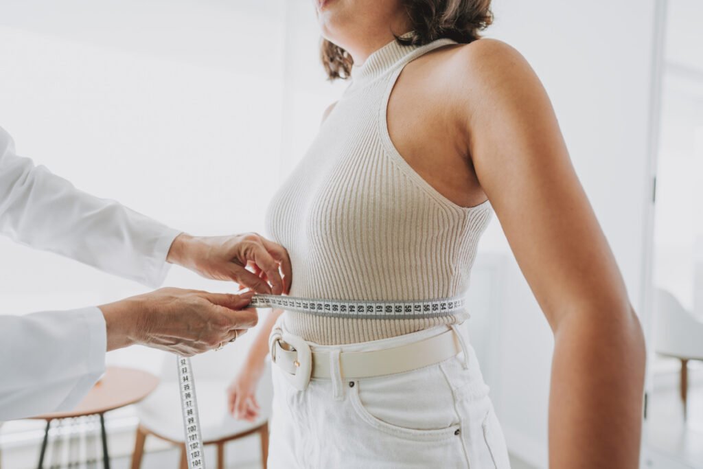 Woman getting measured during a consultation after massive weight loss