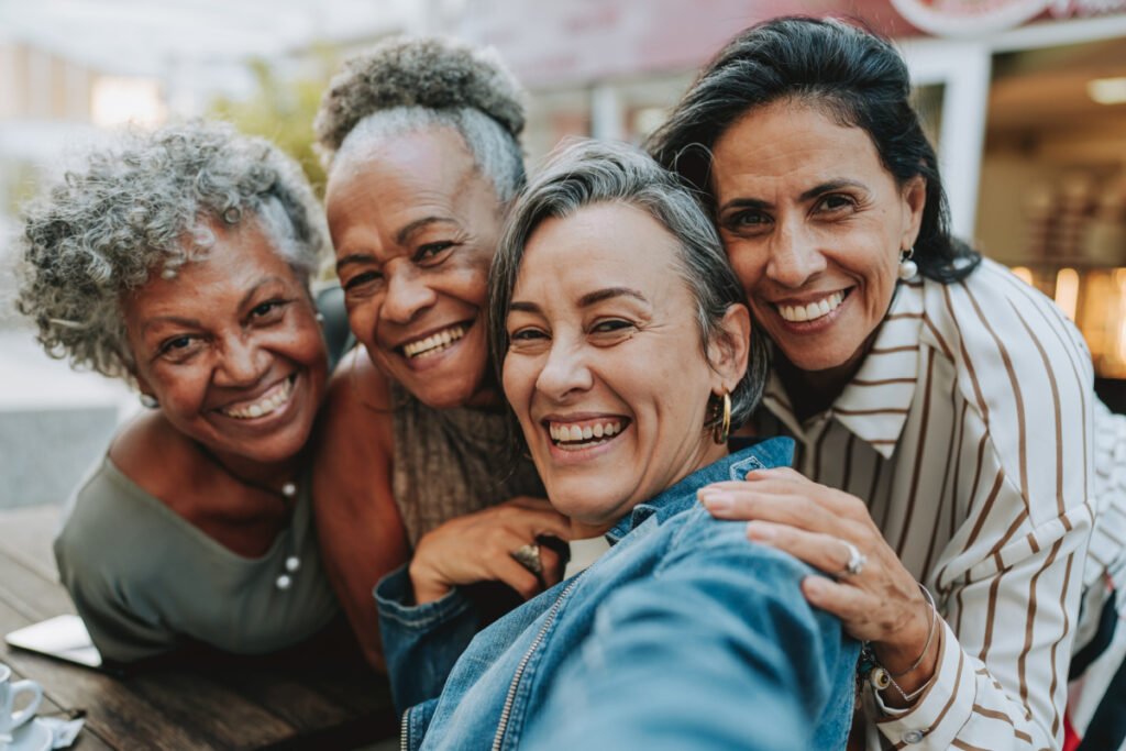 Group of senior women hugging and smiling outside